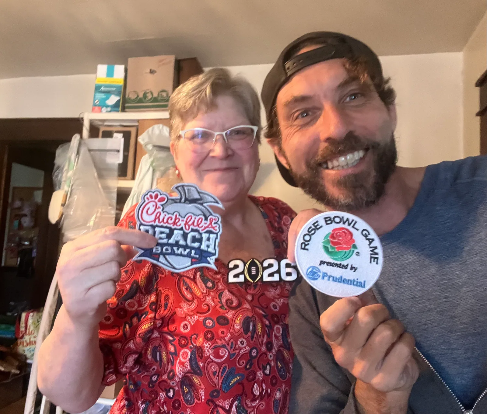 Rabbi MG and an Indiana supporter holding college football keepsakes