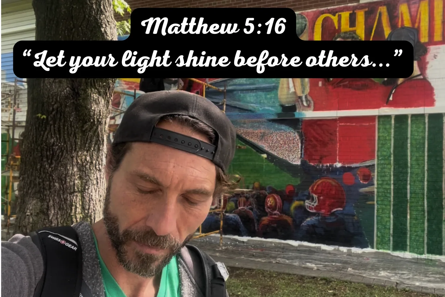 Rabbi MG during the Bloomington prayer walk with Matthew 5:16 displayed above